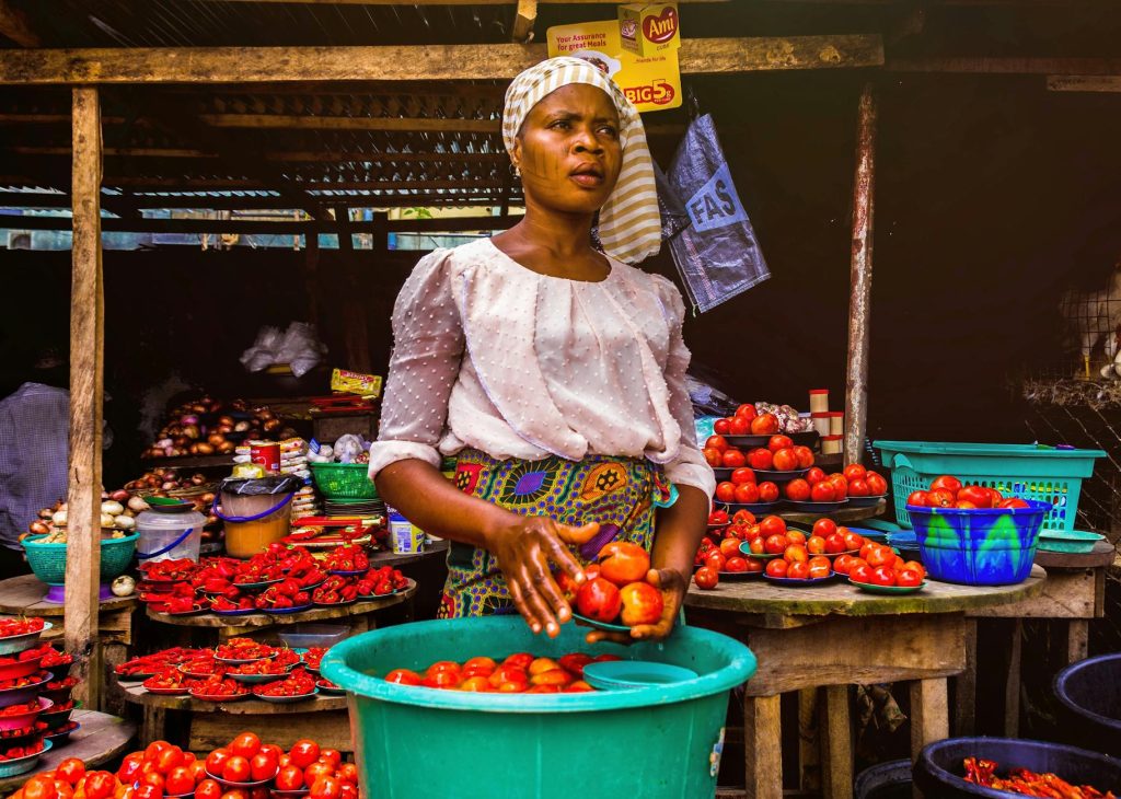 A woman selling beautiful tomatoes at the central market in Yaoundé, Cameroon.